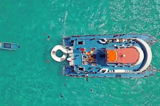 Aerial view of a party catamaran on turquoise water off Cancun